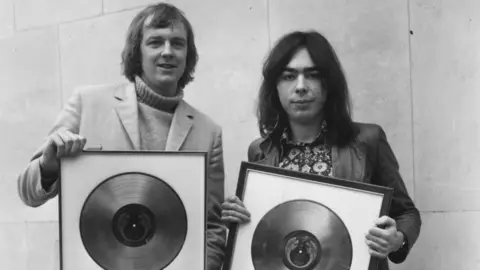 Ron Henbury Black and white image of Tim Rice and Andrew Lloyd-Webber holding gold gold and platinum records for Jesus Christ Superstar in 1973 