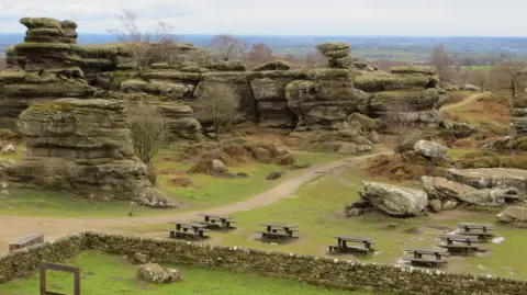 Roy Valentine/Getty Large rock cliffs interspersed with green space and picnic tables