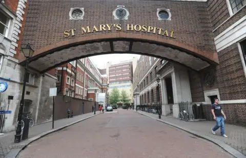 Nick Ansell/PA Images Two hospital buildings connected by a central passage. The structure says 'St Mary's Hospital' in large gold letters