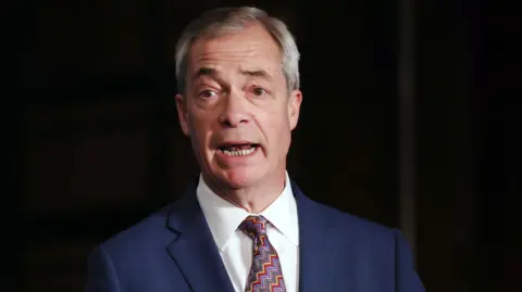 EPA Nigel Farage in blue suit, red and blue patterned tie on dark background