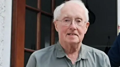 North Yorkshire Police A head and shoulders shot of Fraser Tuddenham. He has white hair, glasses and is wearing a shirt.