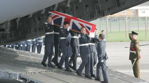 Tim Ockenden / PA / POOL The coffin of Squadron Leader Patrick Marshall, who was one of ten servicemen killed when the C130 Hercules plane they were travelling in crashed in Iraq 30/1/2005, is returned to the UK at RAF Lyneham in Wiltshire, Tuesday February 8, 2005. 