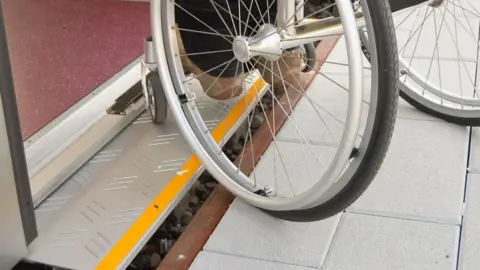 Getty Images Wheelchair struggles to board train 