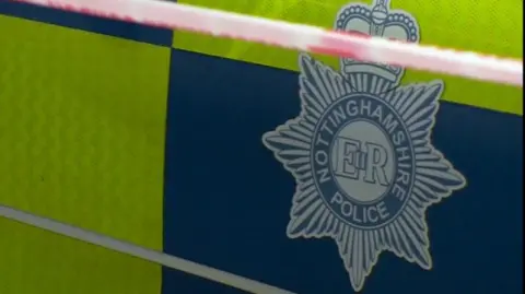 Close up of the Nottinghamshire Police badge on the side of a patrol car