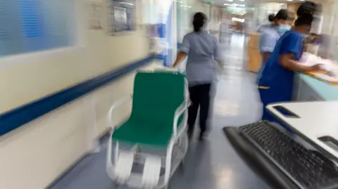 PA A general view of staff on an NHS hospital ward.