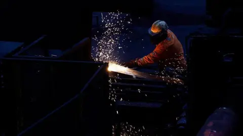 Workers in the rail and sections hot end rolling mill in Scunthorpe