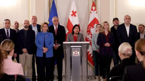 President of Georgia Georgian President Salome Zourabichvili, surrounded by opposition politicians, described the election as a "Russian special operations"