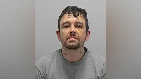 Bedfordshire Police Mugshot of Robert Brown wearing a grey jumper