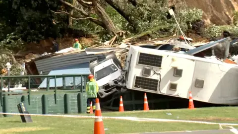Damaged caravans and vehicles remain stuck amid rubble, in the aftermath of a landslide at a campsite triggered by heavy rains in Mount Maunganui, New Zealand
