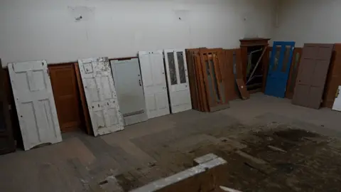Qays Najm/BBC A selection of doors left abandoned inside the building