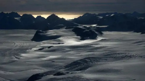 Reuters A snowy Greenland tundra with mountains in the distance