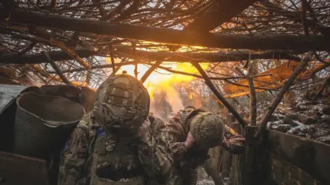 Ukrainian soldiers fire a mortar. File photo
