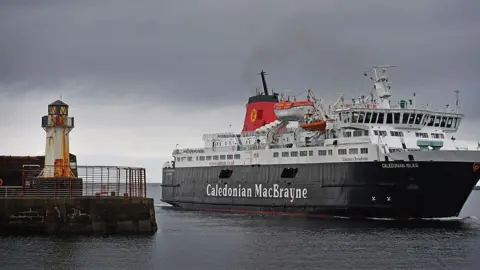 A Caledonian MacBrayne ferry pulling up next to Ardrossan Harbour