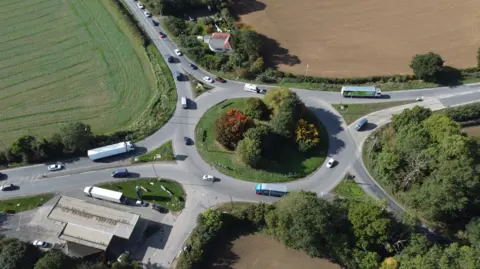 Midlands Connect A roundabout with five roads joining it with cars and lorries driving around it