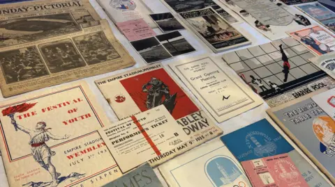 Programmes and tickets from Graham's collection displayed on his kitchen table. 