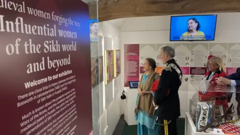 Dignitaries are shown around the exhibition by the Sikh Women from the project 