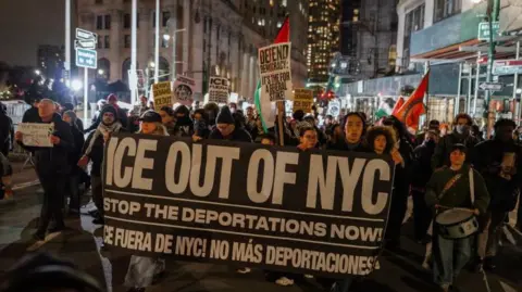 EPA Hundreds of protesters are holding a sign which reads 'Ice out of NYC' as they march through the city. 
