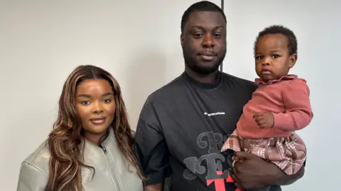 Tawana and Emmanuel, with baby, River after speaking to the BBC's Reliable Sauce podcast