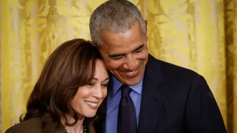 Getty Images Barack Obama and Kamala Harris smile together at a White House event in 2022 to mark the anniversary of the signing of the Affordable Care Act.