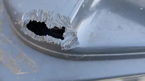 Clare Earley A black bin is pictured with a large chunk missing out of the top of it. 