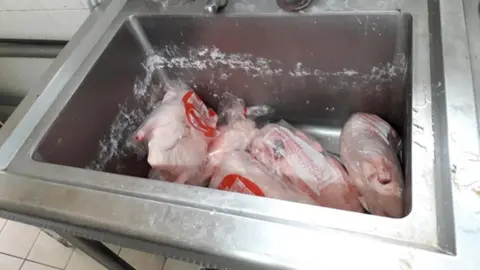 Coventry City Council A large silver sink with at least five chickens left inside in plastic wrappings