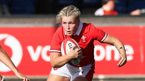Alex Callender carrying the ball for Wales