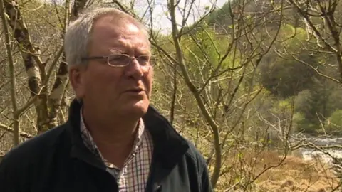 Peter Stanley with trees and the river in the background