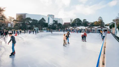 People on a ice rink skating