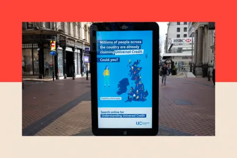 Getty Images An electronic billboard encouraging people to claim Universal Credit