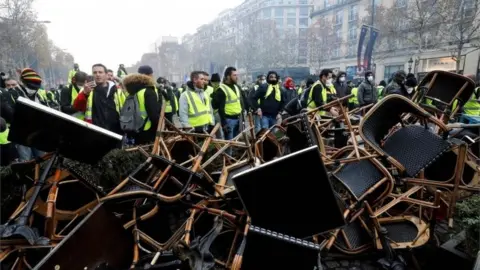 AFP Protesters in Paris man a barricade on the Champs-Elysees, 24 November, 2018