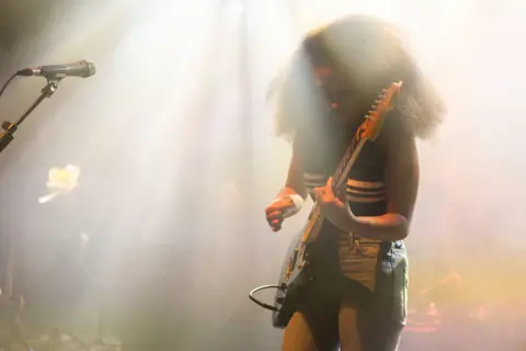 Shutterstock Lily Fontaine dari Guru Bahasa Inggris memetik gitar listrik saat di atas panggung saat konser di Shepherd's Bush Empire London pada November 2024