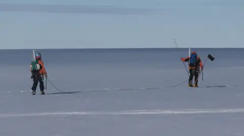 BAS Two scientists walk across the Brunt Ice Shelf