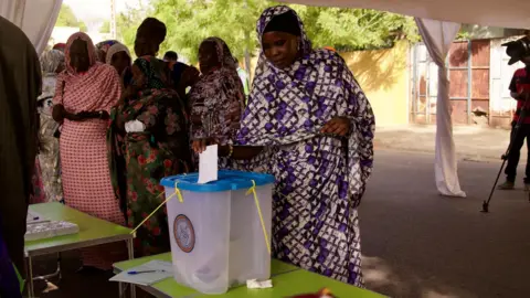 Michel Mvondo/BBC A woman voting