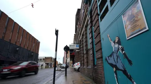 PA Media A wall mural of Dorothy from the Wizard of Oz