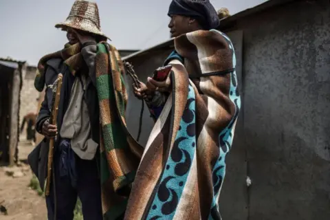 AFP Two herders outside a tavern.