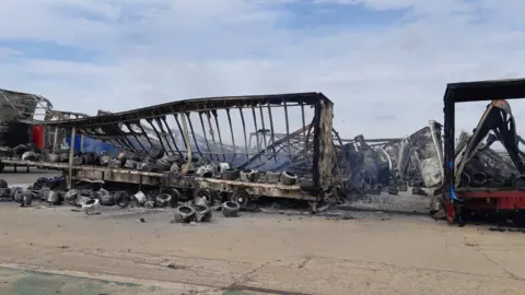 Cambridgeshire Constabulary The charred metal frames of the trailers