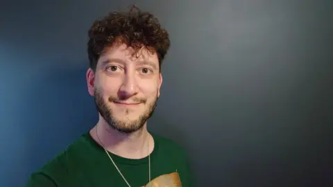 Jim Woods Jim Woods wearing a green shirt and smiling