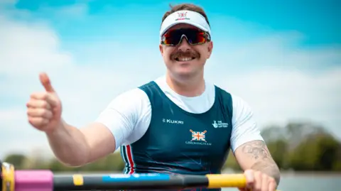 Ben Pritchard smiles and gives a thumbs up gesture