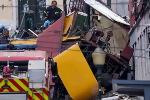 EPA Rescuers and firefighters operate at the scene after the Gloria funicular cable railway derailed