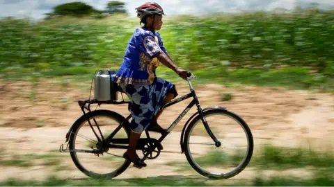 Woman on bike in Zambia