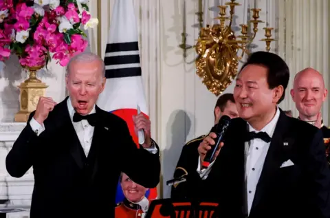 Evelyn Hockstein / Reuters US President Joe Biden reacts as South Korea's President Yoon Suk Yeol