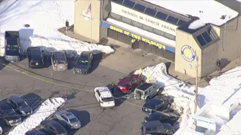 The scene of a school shooting with multiple cars.