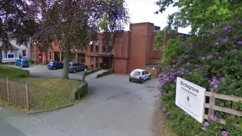 Google A general view picture of the nursing home, a two-storey brick building with cars four cars parked outside the entrance area.