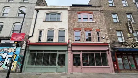 113 and 115 Redchurch Street. Two renovated weavers' cottages with 113 having a green front and 115 coloured in pink