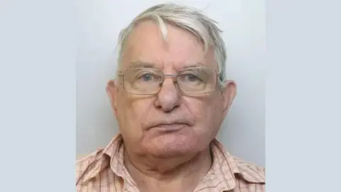 Avon and Somerset Police A police mugshot of an elderly man with grey hair and glasses