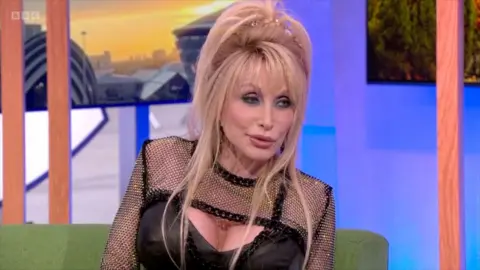 Dolly Parton sat on the One Show sofa speaking to presenters