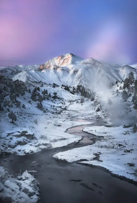 Greg Stokesbury A river in front of a snow-covered mountain