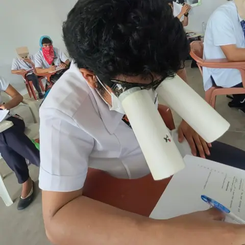 Mary Joy Mandane-Ortiz A student wears homemade goggles during a college exam in the Philippines