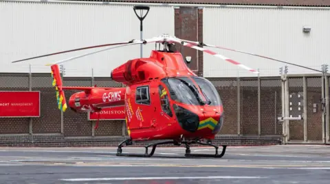 Getty Images Red air ambulance helicopter on the ground