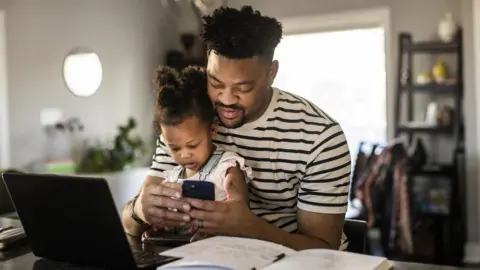 Getty Images A stock photo of a child and adult browsing online